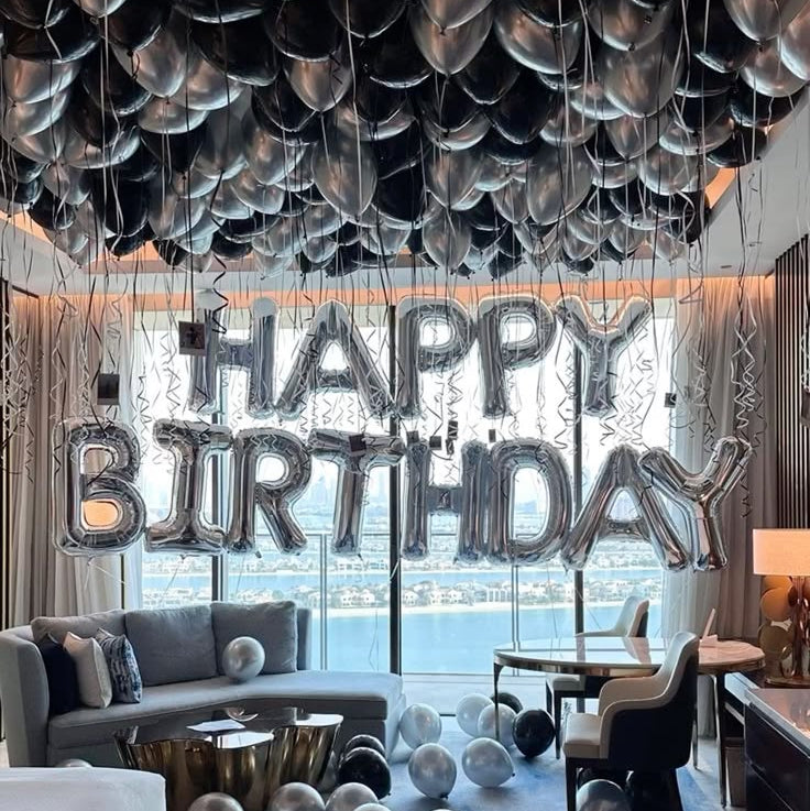 Luxury black and chrome silver helium ceiling balloon decoration for birthday surprise setup in Dubai hotel apartment